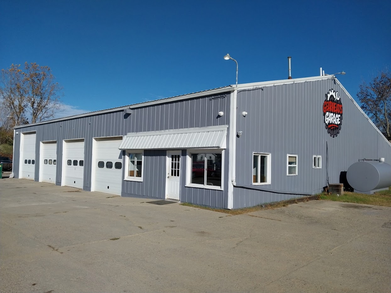 Exterior of Gearheads Garage in Lapeer, Michigan with open service bays at sunrise